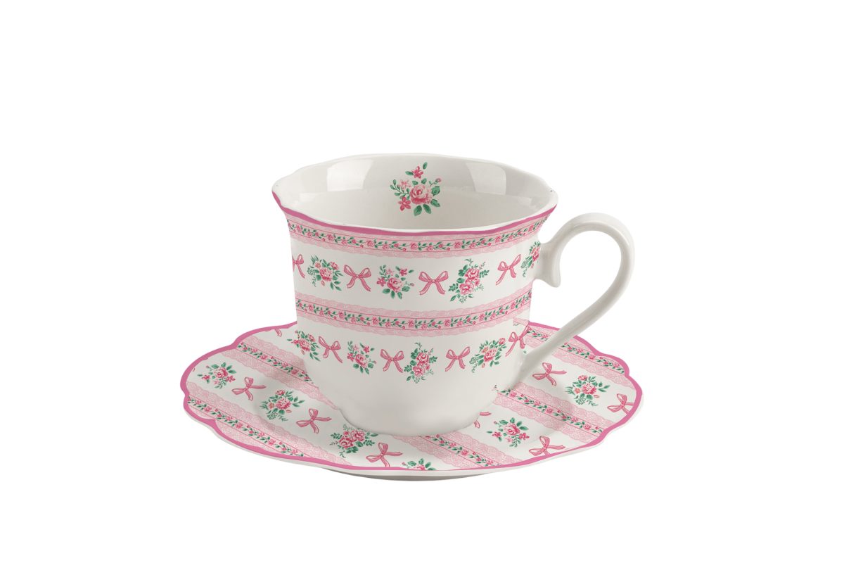 Cute porcelain cup with handle and saucer with ribbons and roses design.