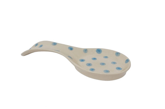 Ceramic handmade spoon rest in ivory colour with blue dots.